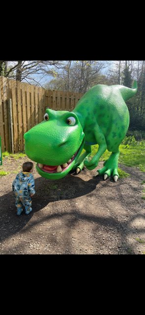 A toddler looking up at Dinosaur Munch