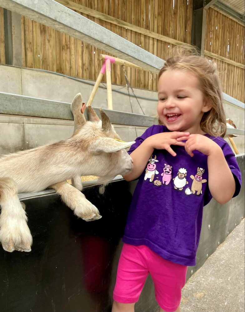 girl wiht goat in farmer palmer t-shirt