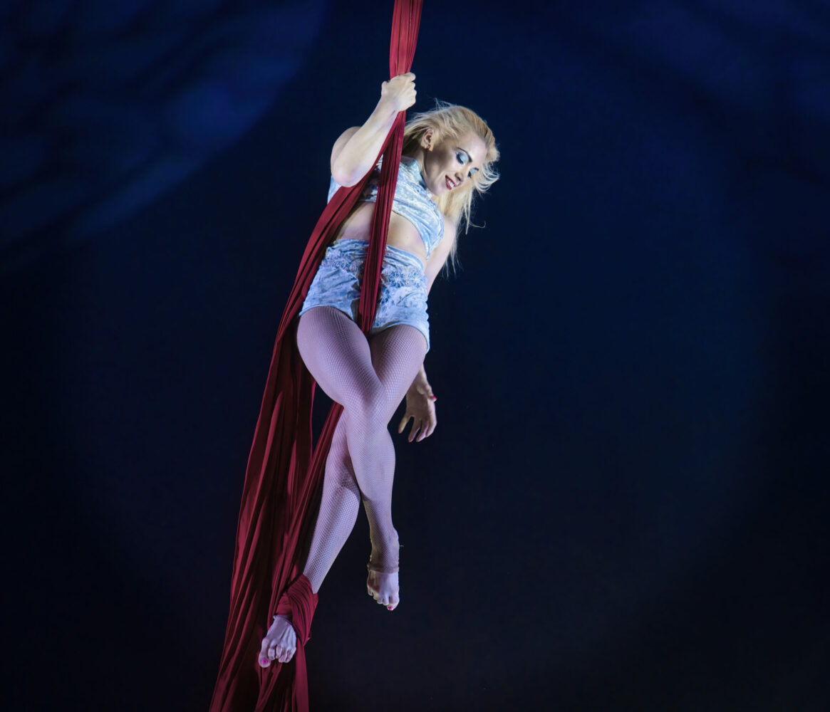 Circus lady suspended in silks Happy’s Circus at Farmer Palmers