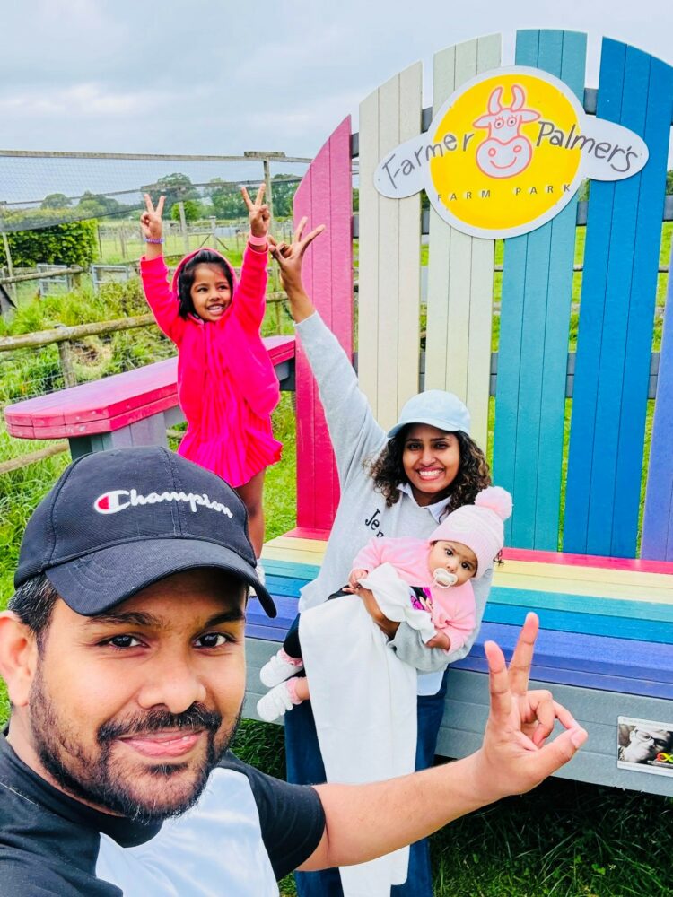 Family on Farmer Palmers big rainbow chair