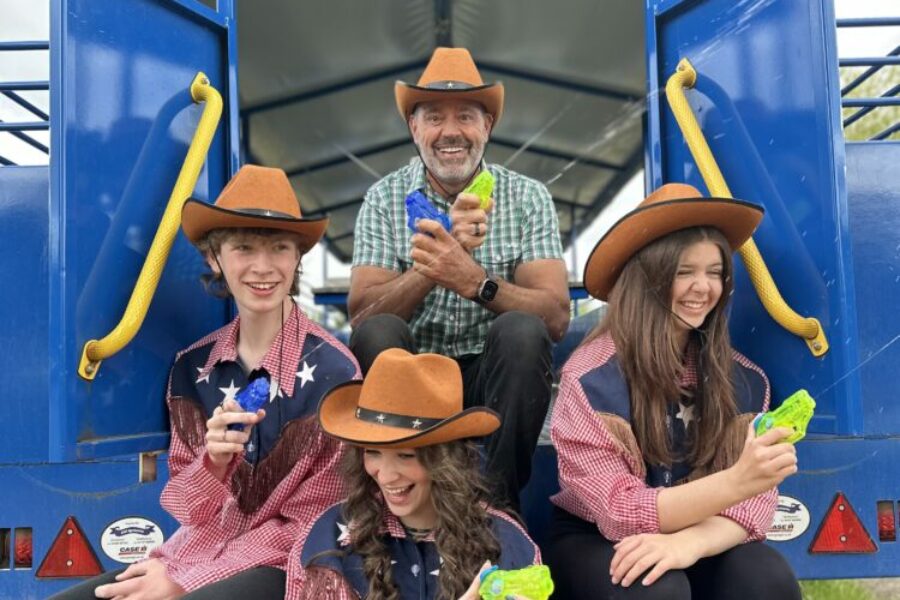 4 people with water pistols on the Wet the Western Tractor trailer ride