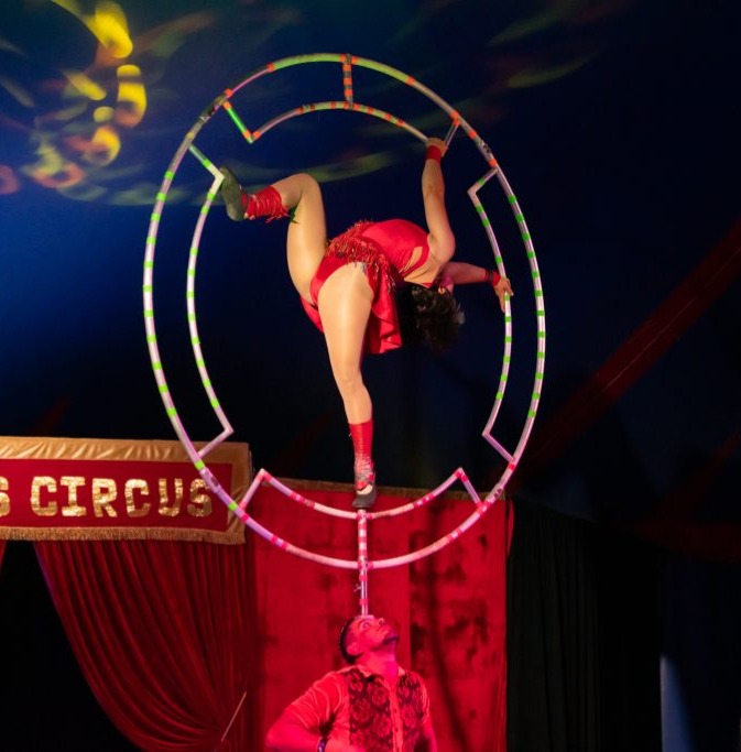 Happys Circus performers woman in wheel above man