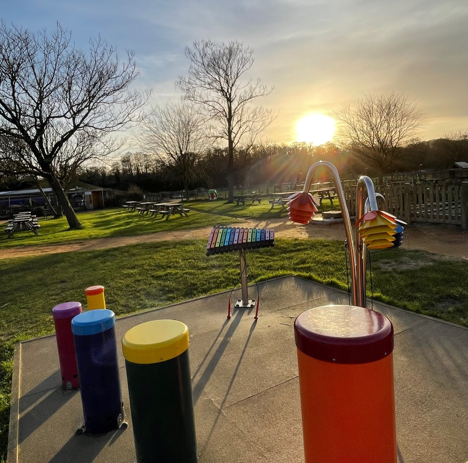sunset over percussion play area at farmer palmers farm park.