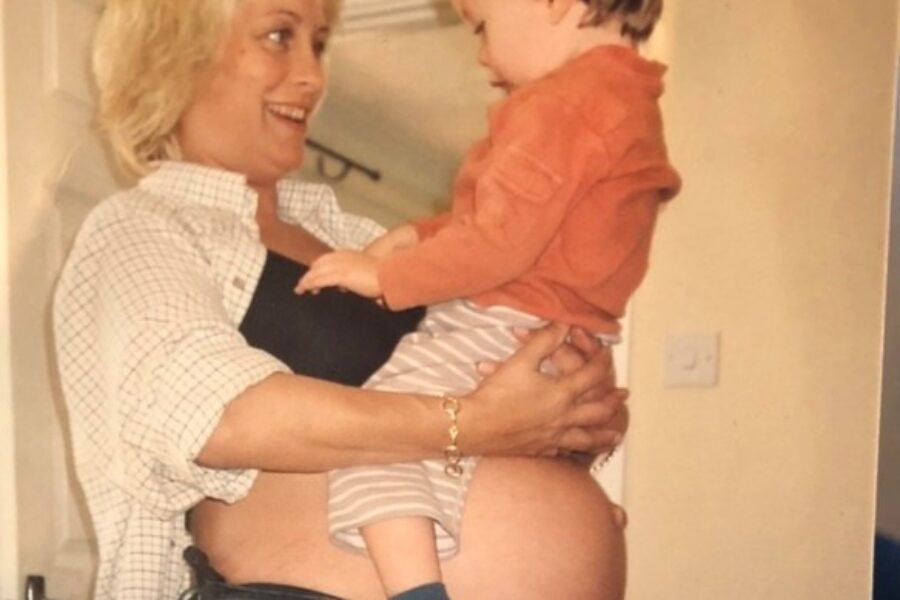 Pregnant woman with child sat on her belly
