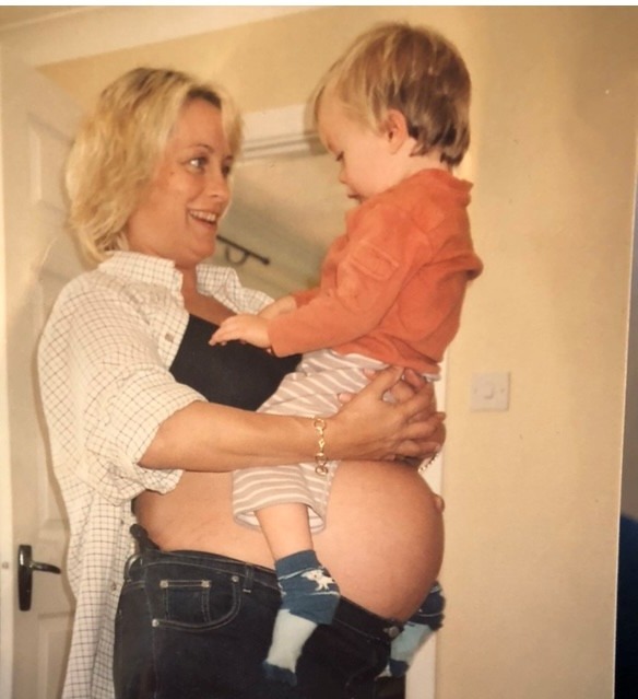 Pregnant woman with child sat on her belly