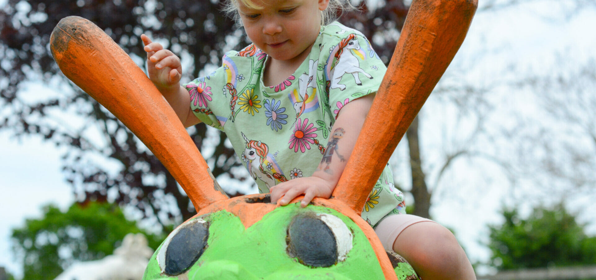 girl on caterpillar - trim trail