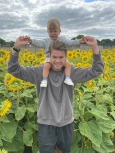 Father and son in the sunflower field at Farmer Palmers