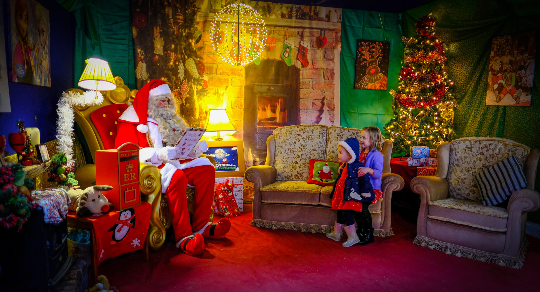 Child meeting Farmer Christmas in his grotto at farmer palmers